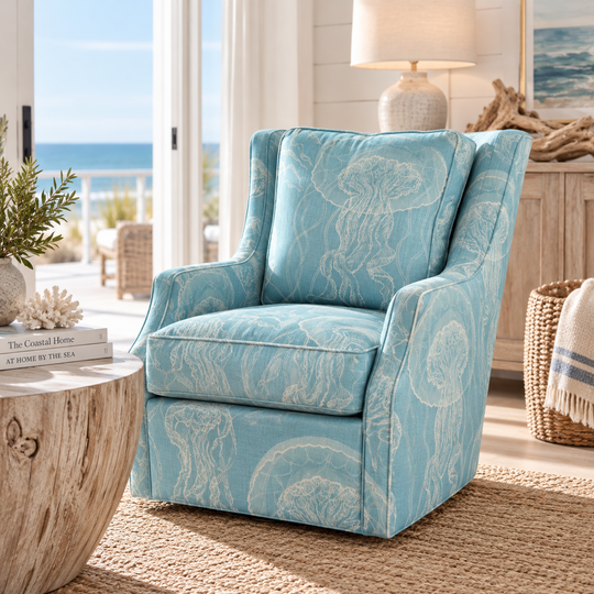 Solana chair in sea-blue fabric with ivory jellyfish artwork, shown from a three-quarter angle in a coastal room.